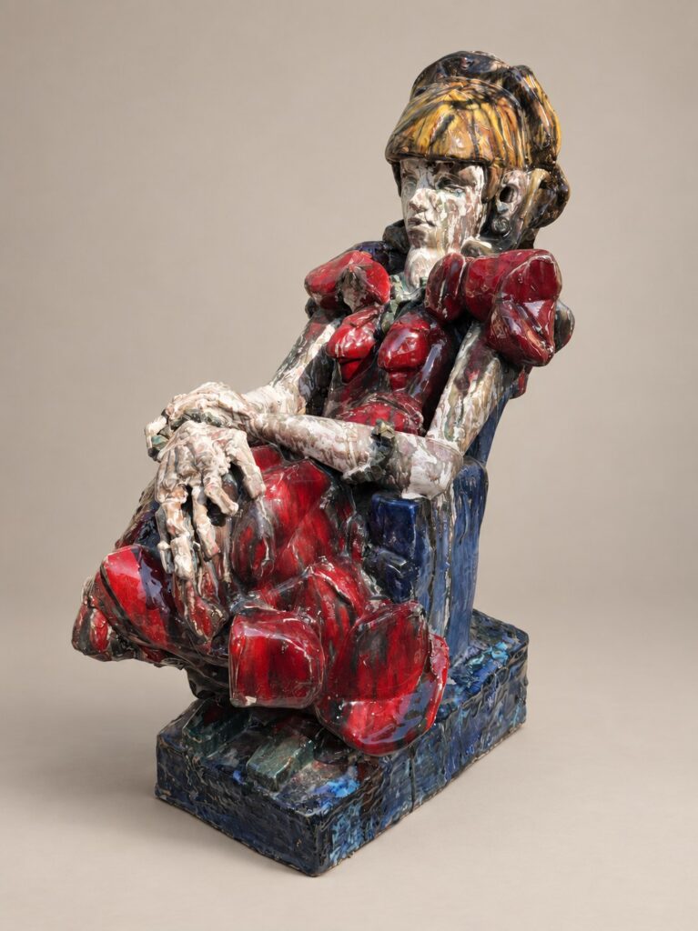 Woman in a red dress on a blue throne. Ceramic sculpture by Ted Fullwood