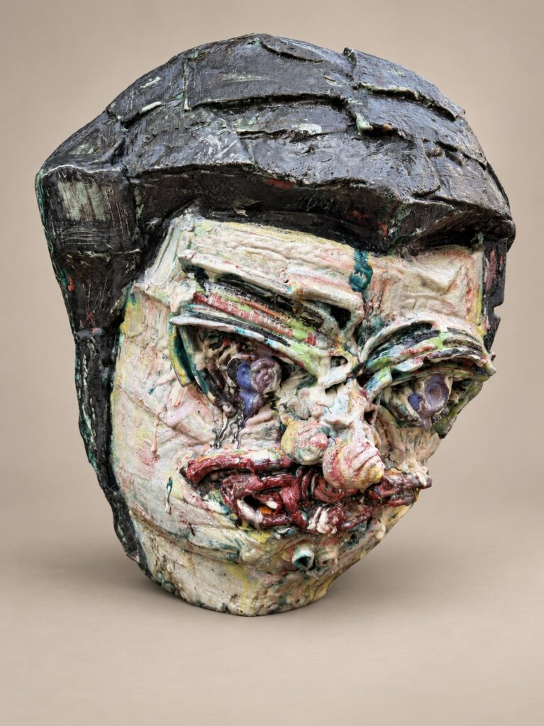Head with glossy black hair. Ceramic sculpture by Ted Fullwood
