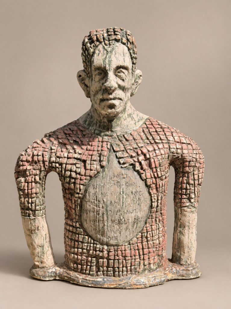 Bust with a grid-textured torso and circular medallion. Ceramic sculpture by Ted Fullwood